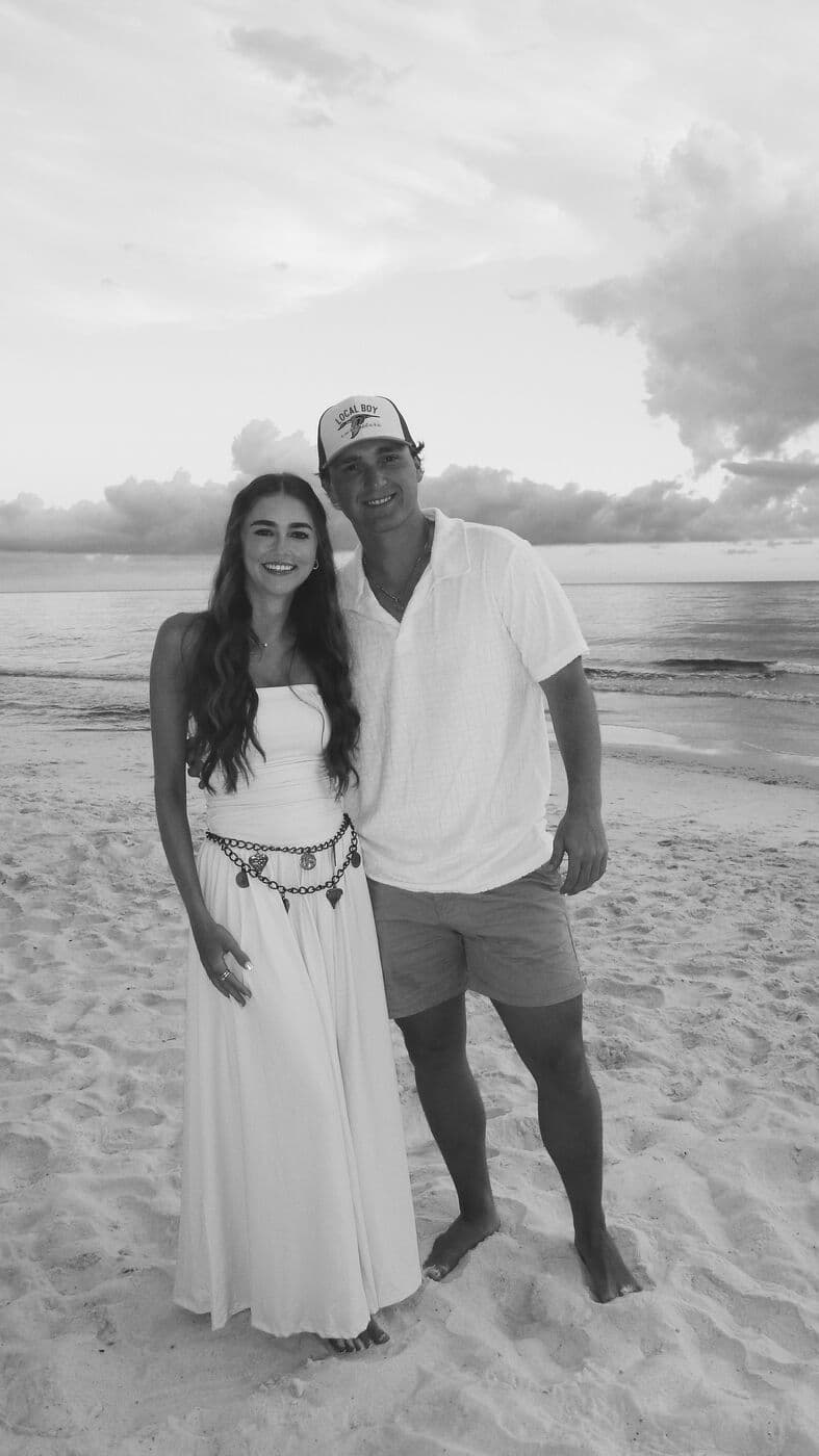 Elise and Tyler on the sand under a big sky, in black and white