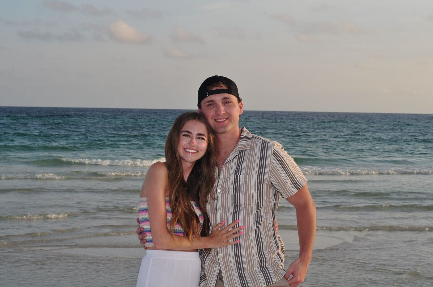 Elise and Tyler on the shoreline at dusk